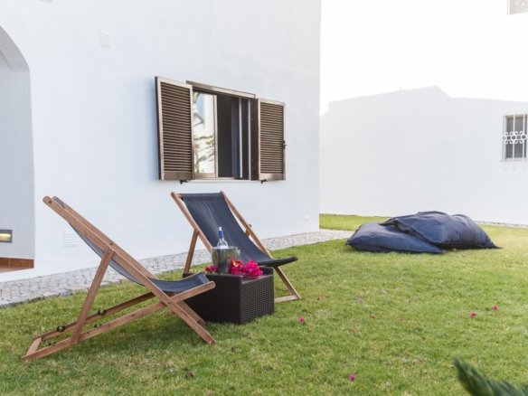 summer apartment garden with chairs and pillows setup